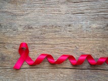 Лента помощи красная на деревянной предпосылке для Международного дня СПИДА и nati стоковые изображения rf Лента помощи красная на деревянной предпосылке для Международного дня СПИДА и nati стоковые изображения rf