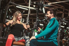 Личный тренер давая поднятие тяжестей тренируя к девушке Стоковое Изображение RF Личный тренер давая поднятие тяжестей тренируя к девушке Стоковое Изображение RF