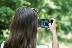 Маленькая девочка мобильным телефоном фотографирует ландшафт с a стоковое фото Маленькая девочка мобильным телефоном фотографирует ландшафт с a стоковое фото
