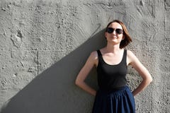 Маленькая девочка представляя против бетонной стены, одетой в черных, трудных свете и тенях стоковое фото Маленькая девочка представляя против бетонной стены, одетой в черных, трудных свете и тенях стоковое фото