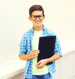 мальчик подростка портрета усмехаясь в eyeglasses с папкой или книгой стоковое изображение rf мальчик подростка портрета усмехаясь в eyeglasses с папкой или книгой стоковое изображение rf