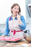 Милая молодая женщина печь вкусные булочки дома стоковое изображение rf Милая молодая женщина печь вкусные булочки дома стоковое изображение rf