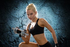 Молодая sporty женщина с тяжелой стальной гантелью Стоковая Фотография Молодая sporty женщина с тяжелой стальной гантелью Стоковая Фотография