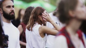 Молодая женщина брюнет в белых танцах рубашки в людях толпится на под открытым небом концерте акции видеоматериалы Молодая женщина брюнет в белых танцах рубашки в людях толпится на под открытым небом концерте акции видеоматериалы