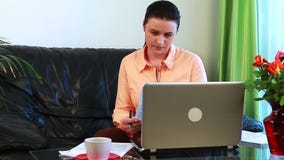 Молодая женщина потревожилась о оплачивать счеты Молодая женщина потревожилась о оплачивать счеты