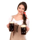 Молодая сексуальная женщина нося dirndl с изолятом 2 кружек пива стоковое фото Молодая сексуальная женщина нося dirndl с изолятом 2 кружек пива стоковое фото
