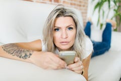 Молодая женщина с голубыми контактными линзами используя умный телефон стоковые фотографии rf Молодая женщина с голубыми контактными линзами используя умный телефон стоковые фотографии rf