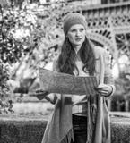 Молодая туристская женщина на обваловке в Париже, Франции с картой Стоковое фото RF Молодая туристская женщина на обваловке в Париже, Франции с картой Стоковое фото RF