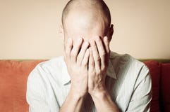 Молодой облыселый человек в рубашке чувствуя отжатая и горемычная крышка его сторона с его руками и выкриком в его комнате стоковые фотографии rf Молодой облыселый человек в рубашке чувствуя отжатая и горемычная крышка его сторона с его руками и выкриком в его комнате стоковые фотографии rf