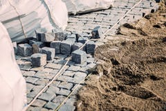 Мостоваая дороги Каменные блоки гранита устанавливают детали Булыжник трясет размещение на тротуаре стоковое фото Мостоваая дороги Каменные блоки гранита устанавливают детали Булыжник трясет размещение на тротуаре стоковое фото