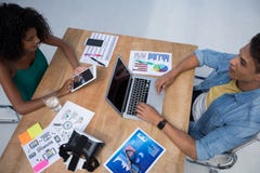 Мужские и женские исполнительные власти работая в офисе стоковые изображения Мужские и женские исполнительные власти работая в офисе стоковые изображения