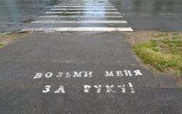 Надпись на асфальте в русском принимает меня вручную! ` crosswalk стоковое фото rf Надпись на асфальте в русском принимает меня вручную! ` crosswalk стоковое фото rf