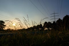 2 опоры линии электропередач и sunrays от захода солнца стоковое изображение rf 2 опоры линии электропередач и sunrays от захода солнца стоковое изображение rf