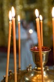 Оранжевые свечи стоят в подсвечнике утюга и огонь освещен стоковое изображение rf Оранжевые свечи стоят в подсвечнике утюга и огонь освещен стоковое изображение rf