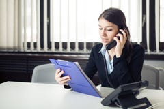 Организованная ответственная бизнес-леди работника офиса давая инструкции через телефонный звонок Смотреть смущенный проверяющ пр Стоковые Фото Организованная ответственная бизнес-леди работника офиса давая инструкции через телефонный звонок Смотреть смущенный проверяющ пр Стоковые Фото