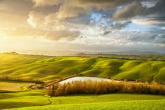 Панорама Тосканы туманная на заходе солнца, Rolling Hills, озере, полях, m Стоковая Фотография RF Панорама Тосканы туманная на заходе солнца, Rolling Hills, озере, полях, m Стоковая Фотография RF