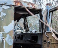 Поврежденная кабина со сломленным стеклом получившегося отказ прежнего военного следа, в зоне отчуждения Чернобыль стоковое фото rf Поврежденная кабина со сломленным стеклом получившегося отказ прежнего военного следа, в зоне отчуждения Чернобыль стоковое фото rf