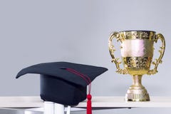 Поздравите студент-выпускника Трофей и черная шляпа на предпосылке стоковое изображение Поздравите студент-выпускника Трофей и черная шляпа на предпосылке стоковое изображение