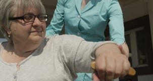 Помогая старшая дама для того чтобы идти медсестра или смотритель помогая дню Outdoors солнечному снятому на красной камере акции видеоматериалы Помогая старшая дама для того чтобы идти медсестра или смотритель помогая дню Outdoors солнечному снятому на красной камере акции видеоматериалы