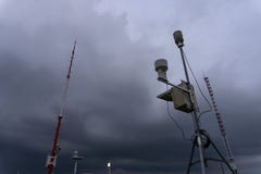 Портативная автоматическая метеорологическая станция в аэропорте Ngurah Rai под страшными темными ливневыми облаками Этот инструм стоковая фотография rf Портативная автоматическая метеорологическая станция в аэропорте Ngurah Rai под страшными темными ливневыми облаками Этот инструм стоковая фотография rf