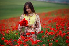 Портрет красоты длинной с волосами молодой модели, усаженный в маки поле, предпосылка летнего дня стоковая фотография rf Портрет красоты длинной с волосами молодой модели, усаженный в маки поле, предпосылка летнего дня стоковая фотография rf