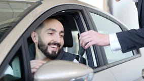 Посетите выставочный зал Молодой человек получает ключи автомобиля владением, смотря камеру и усмехаться, сидя в его новом автомо стоковая фотография Посетите выставочный зал Молодой человек получает ключи автомобиля владением, смотря камеру и усмехаться, сидя в его новом автомо стоковая фотография