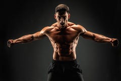 представлять культуриста Человек muscled фитнесом на темной предпосылке Реветь для мотивировки стоковое фото представлять культуриста Человек muscled фитнесом на темной предпосылке Реветь для мотивировки стоковое фото