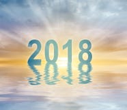 Предпосылка нерезкости захода солнца текста чисел Нового Года 2018 стоковое фото rf Предпосылка нерезкости захода солнца текста чисел Нового Года 2018 стоковое фото rf