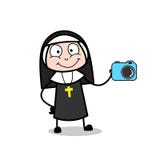 Продавщица монашки шаржа представляя вектор цифровой фотокамера Стоковые Фото Продавщица монашки шаржа представляя вектор цифровой фотокамера Стоковые Фото