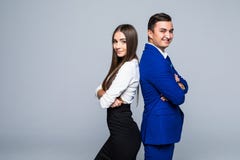 2 профессионала в деле и финансах в серых куртках и джинсах стоя спиной к спине на сером цвете стоковое фото rf 2 профессионала в деле и финансах в серых куртках и джинсах стоя спиной к спине на сером цвете стоковое фото rf