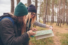 Путешественники женщин с картой и компасом стоковая фотография Путешественники женщин с картой и компасом стоковая фотография