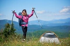 Располагаться лагерем женщины туристский близко в горах с рюкзаком и trekking ручками в утре стоковые фото Располагаться лагерем женщины туристский близко в горах с рюкзаком и trekking ручками в утре стоковые фото