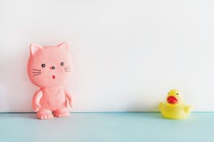 Резиновые игрушки на голубой и белой предпосылке Розовый резиновый кот и желтая резиновая утка стоя совместно Игрушки ванны стоковое фото Резиновые игрушки на голубой и белой предпосылке Розовый резиновый кот и желтая резиновая утка стоя совместно Игрушки ванны стоковое фото