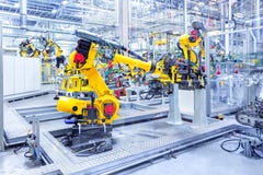 Роботы в заводе автомобиля стоковое фото Роботы в заводе автомобиля стоковое фото