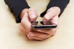 Руки на smartphone стоковое изображение rf Руки на smartphone стоковое изображение rf