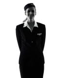 Силуэт женщины летного обслуживающего персонала Stewardess изолированный положением стоковое изображение rf Силуэт женщины летного обслуживающего персонала Stewardess изолированный положением стоковое изображение rf