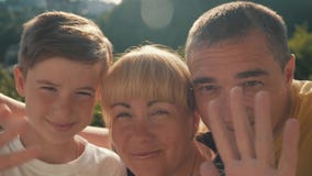 Счастливая семья Skype Они говорят здравствуйте и улыбка, взгляд на камере и развевают их руки Мать, сын и отец сток-видео Счастливая семья Skype Они говорят здравствуйте и улыбка, взгляд на камере и развевают их руки Мать, сын и отец сток-видео