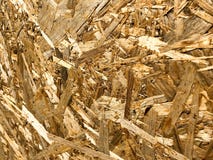 Текстуры от угла деревянного желтого строительного материала от shavings и обжатой опилк OSB, отхода продукции мебели стоковые изображения Текстуры от угла деревянного желтого строительного материала от shavings и обжатой опилк OSB, отхода продукции мебели стоковые изображения