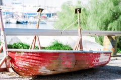Тонуть красная шлюпка с отверстиями в бортовом ремонте в сухом доке Афиныы, Греция стоковое изображение Тонуть красная шлюпка с отверстиями в бортовом ремонте в сухом доке Афиныы, Греция стоковое изображение