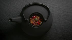 Традиционное азиатское расположение церемонии чая Чайник утюга, чашки, высушенные цветки стоковое изображение Традиционное азиатское расположение церемонии чая Чайник утюга, чашки, высушенные цветки стоковое изображение