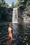 Человек на водопаде наслаждается взглядом и перемещением стоковая фотография Человек на водопаде наслаждается взглядом и перемещением стоковая фотография