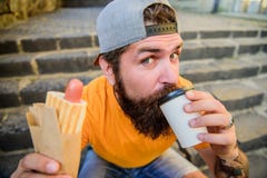 喝不同的事 白种人行家喜欢喝与热狗的外带的饮料 采取饮者的有胡子的人 免版税库存图片 喝不同的事 白种人行家喜欢喝与热狗的外带的饮料 采取饮者的有胡子的人 免版税库存图片