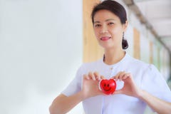 微笑的红色心脏由在医疗保健医院或诊所的微笑的女性护士` s手举行了 专家,专家,被体验 免版税图库摄影 微笑的红色心脏由在医疗保健医院或诊所的微笑的女性护士` s手举行了 专家,专家,被体验 免版税图库摄影