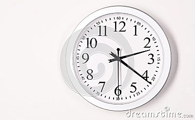 Plain White Wall Clock Shows Time 2:21 Stock Photo