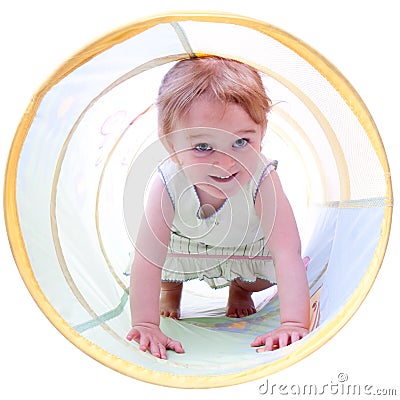 2 Year Old Girl Crawling in a Tunnel Stock Photo