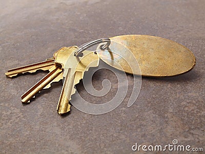 3 Keys and keychain on tile Stock Photo