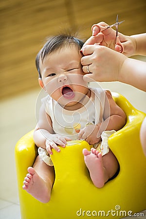 4 Month Old Asian Baby Girl Having A Haircut Stock Image 