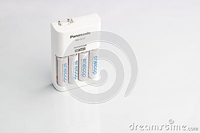 AA Rechargeable long lasting batteries with compatible charger - Wide angle Editorial Stock Photo