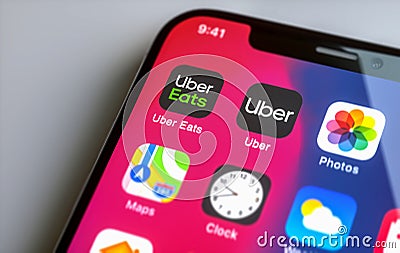 Apple iphone with Uber and Uber Eats App on screen. Uber is an American company offering different transportation services online Editorial Stock Photo