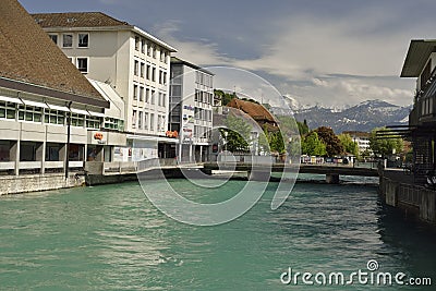 Aare reiver from city of Thun with Swiss Alps in background, Switzerland Editorial Stock Photo